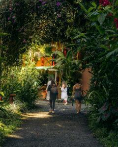 A group walks through the jungle at The Goddess Garden