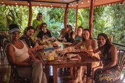 A group wellness retreat enjoys a meal together