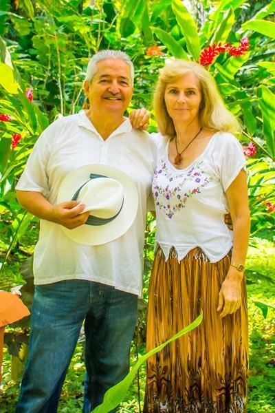 A photo of Jacqueline Bürkler & Marcelo Ruiz in the jungle surrounded by greenery and tropical flowers 